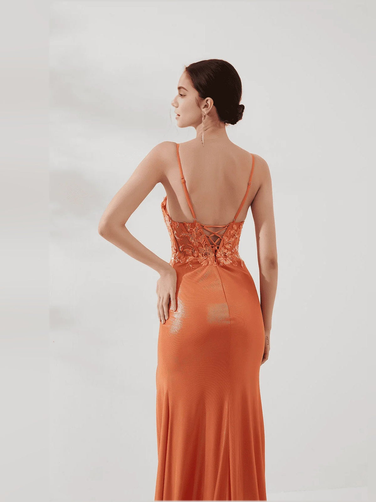 Orange open-back corset mermaid prom dress with floral embroidery and thin straps