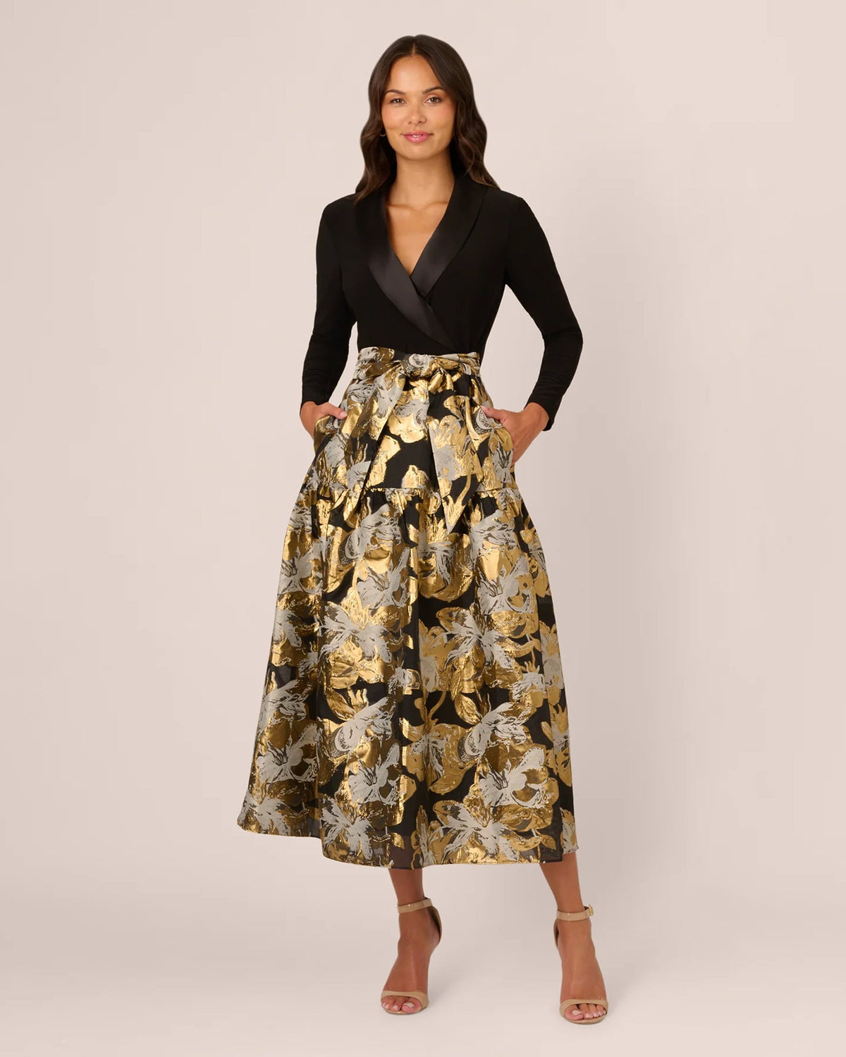 A-line maxi dress, black wrap-style bodice with long sleeves and gold floral-print skirt