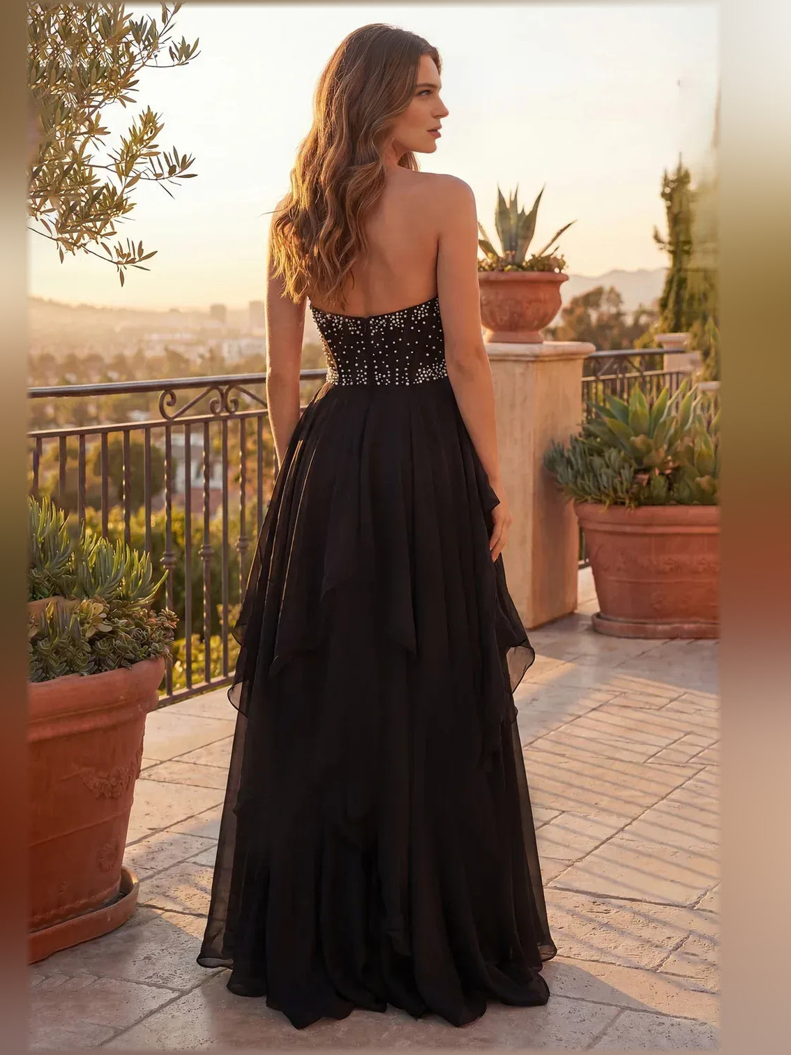 Black strapless tiered ruffle formal dress, back view, floor-length