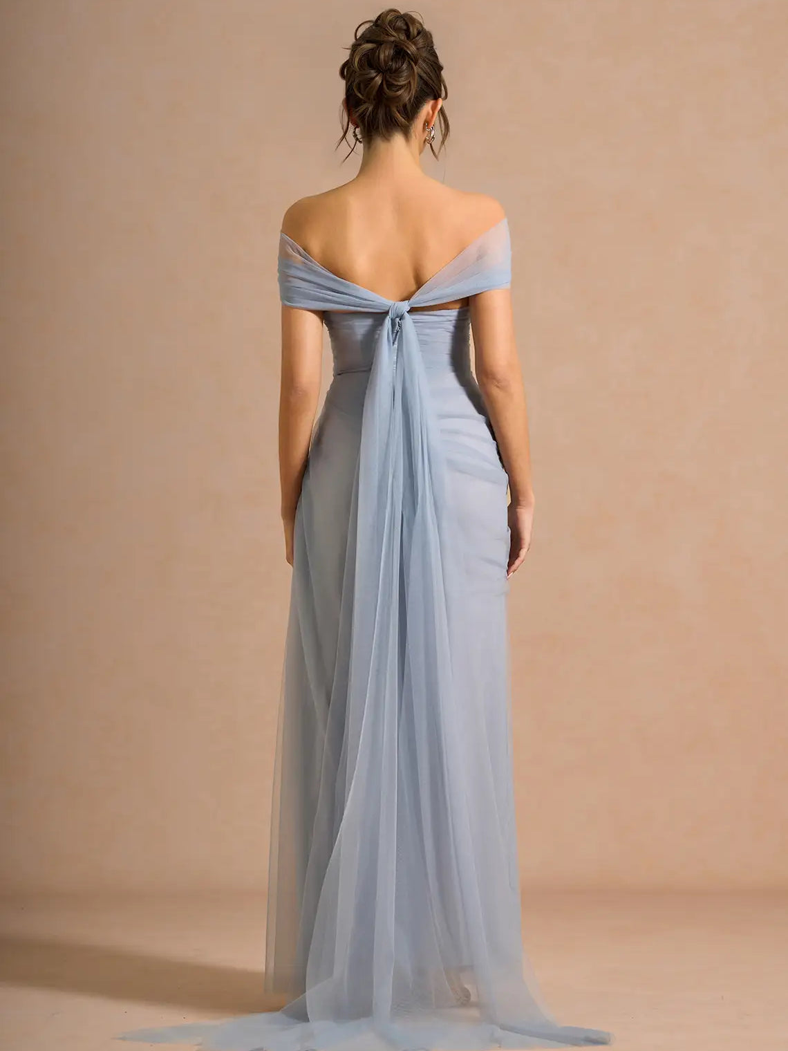 Off-shoulder formal dress in powder blue, open back with draped detail and long skirt