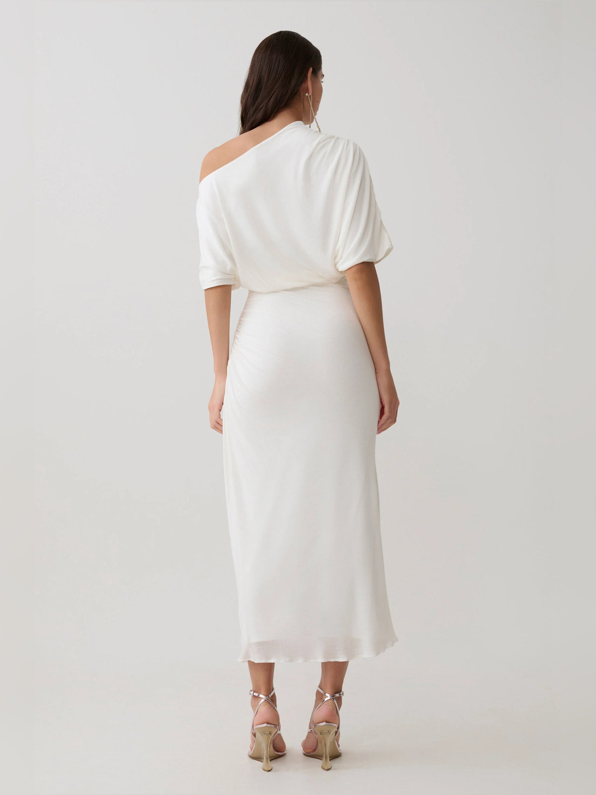 White draped one-shoulder midi dress, back view, gathered waist and short sleeves