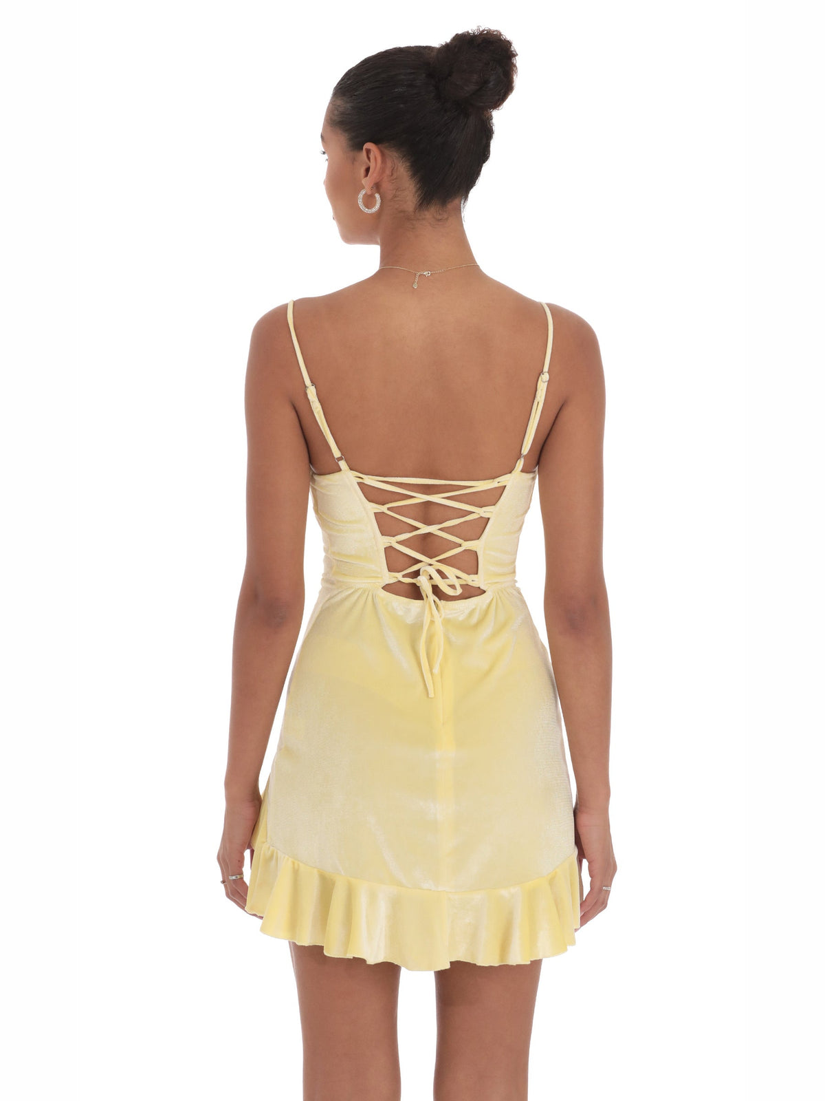 Back view of yellow satin A-line mini dress with lace-up corset and ruffle hem