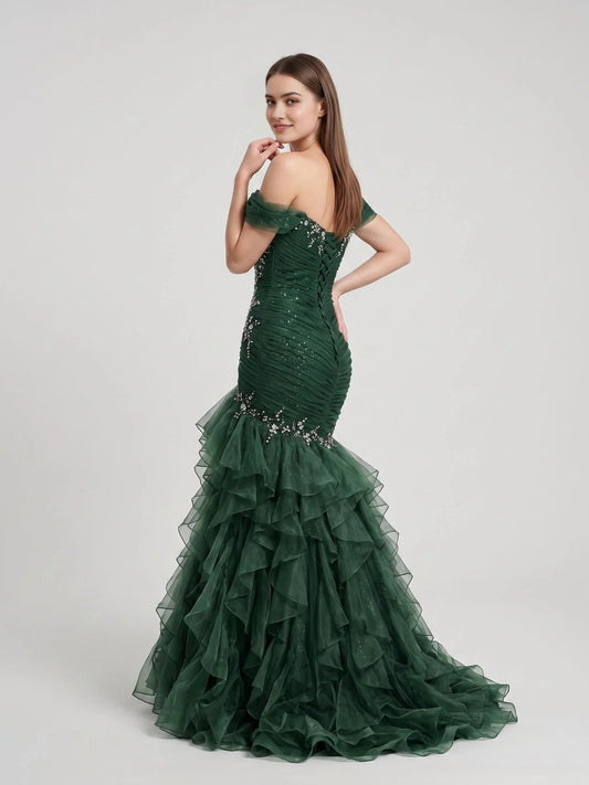 Emerald green ruched off-shoulder corset gown with sparkling detail and layered ruffle skirt