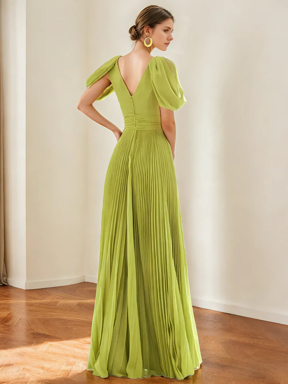 Olive green V-neck formal dress with puff sleeves, fitted waist, and pleated floor-length skirt