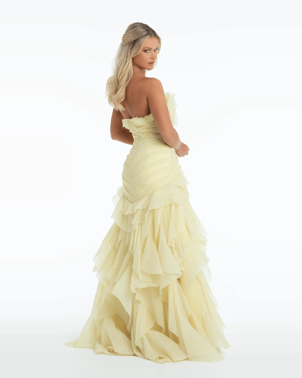 Yellow strapless A-line maxi prom dress with tiered pleated ruffles, side profile