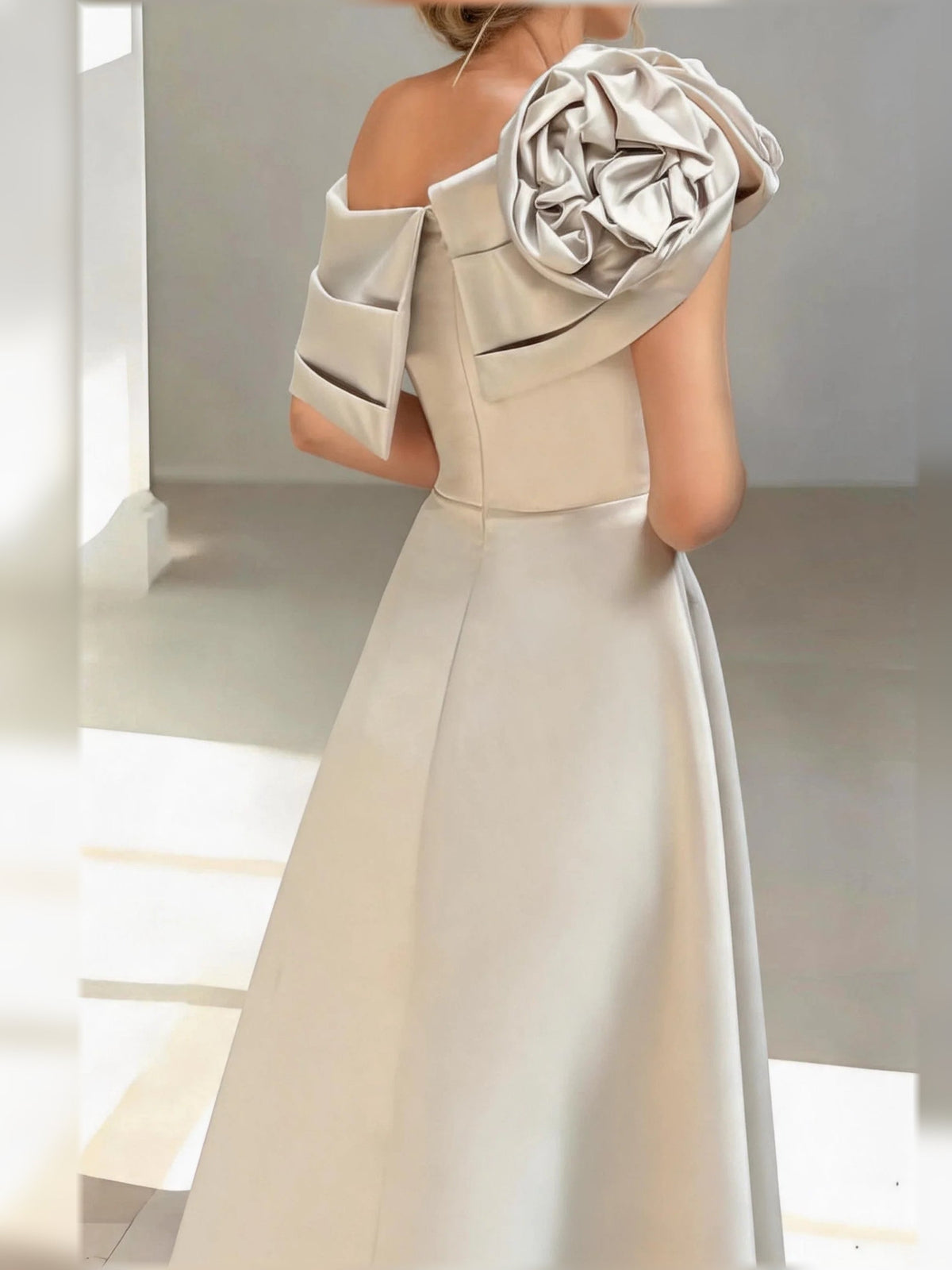 Champagne satin one-shoulder A-line dress with rosette shoulder drape and folded overlay