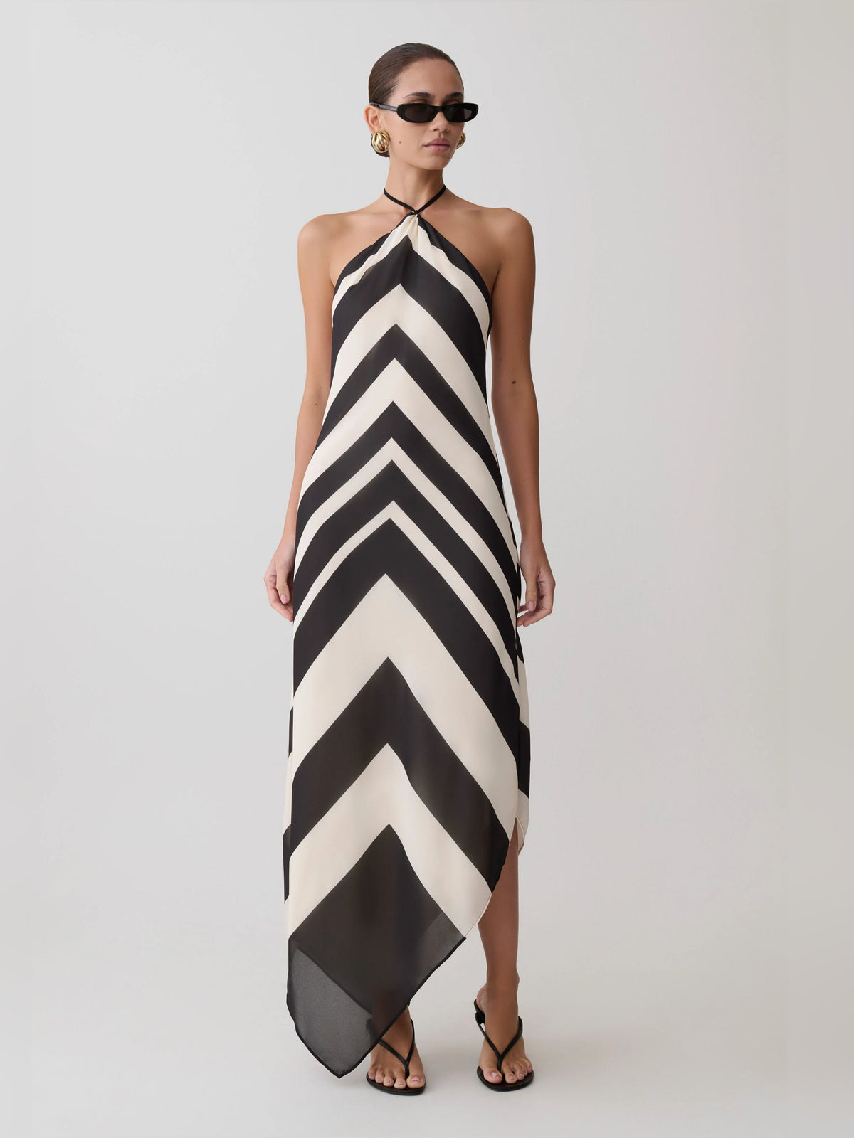 Satin halter midi formal dress in black-and-white chevron zigzag, halter neckline, high slit.