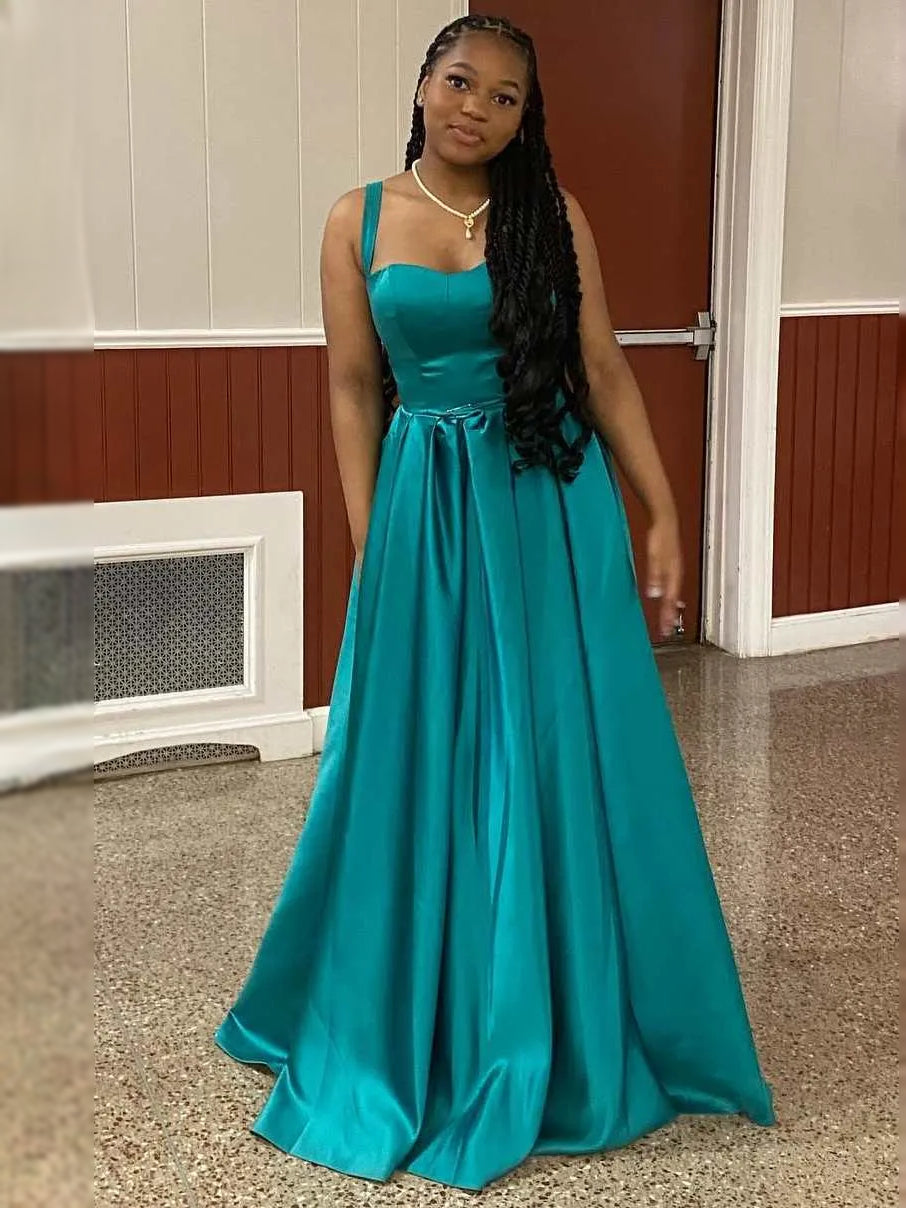 Teal satin sweetheart ball gown with gathered waist bow and flowing floor-length skirt