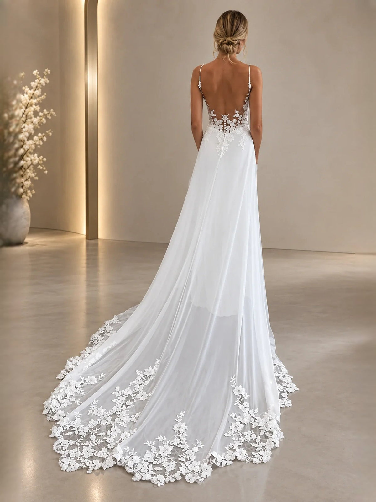 White backless A-line wedding dress with lace back detail and long scalloped train