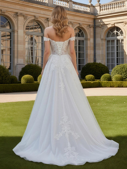 Ivory open-back corset wedding dress with floral tulle A-line skirt, flowing hem