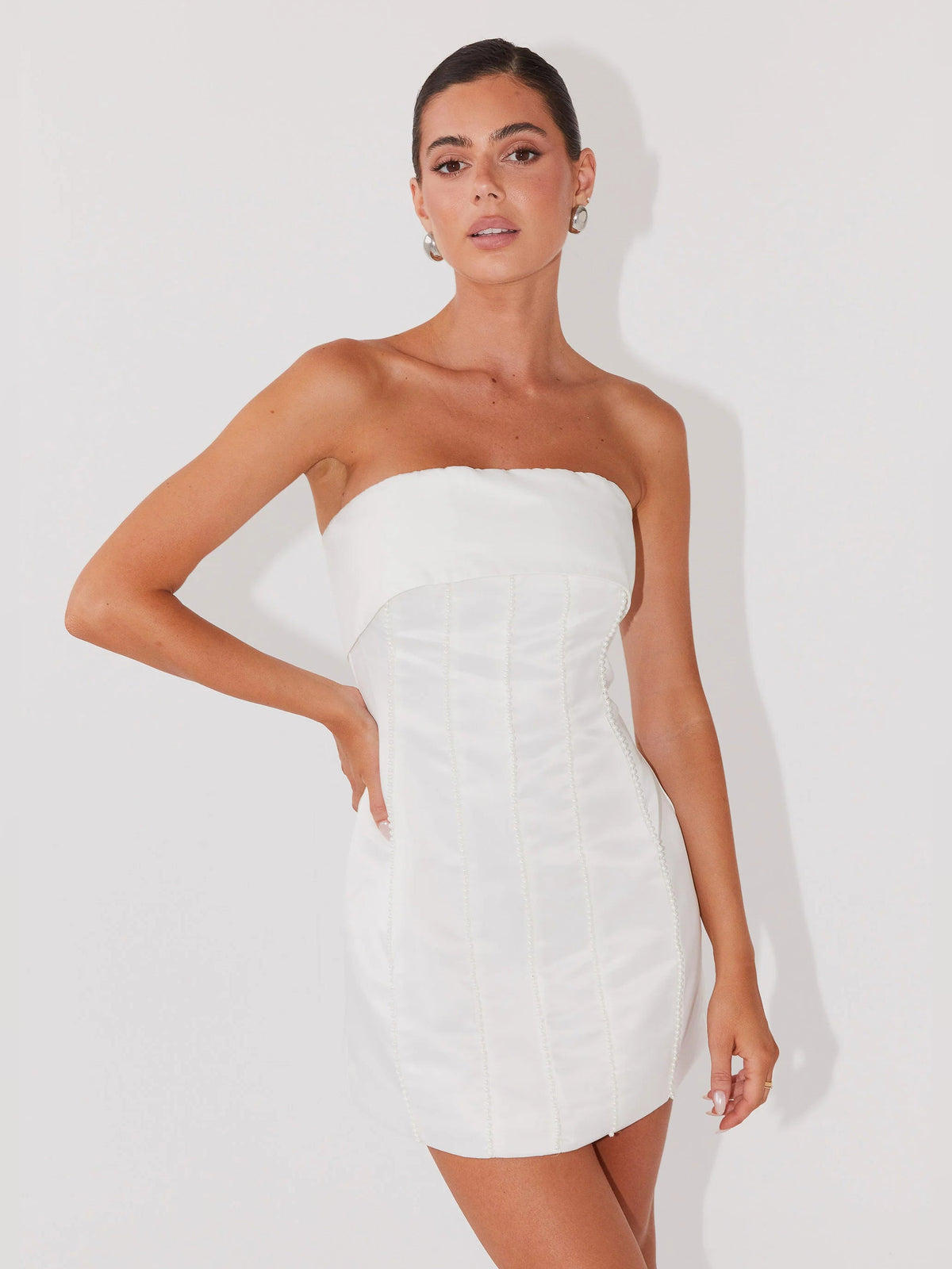 Pearl strapless mini dress with bandeau neckline, fitted seams, and straight mini hem