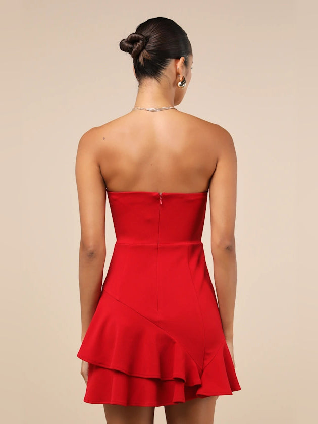 Back view of red strapless mini dress with seam shaping and ruffled hem