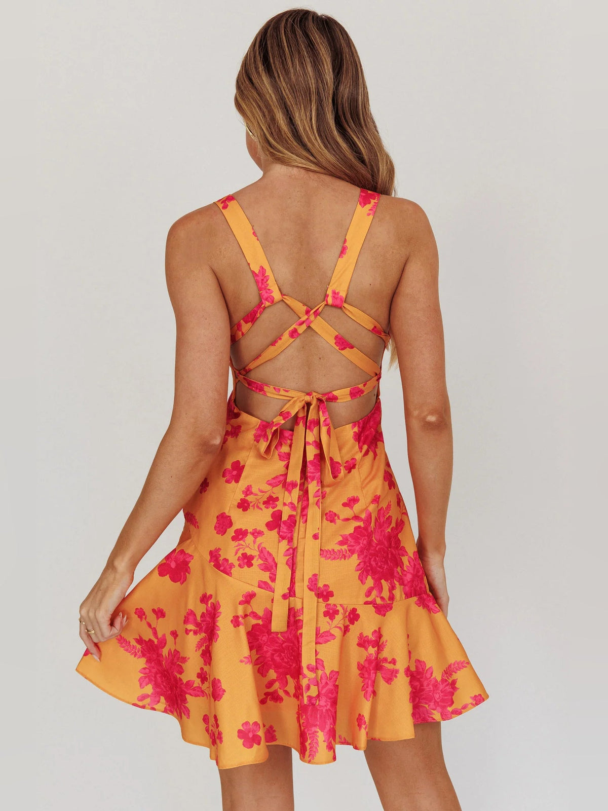 Orange floral mini homecoming dress with lace-up open back and bow detail