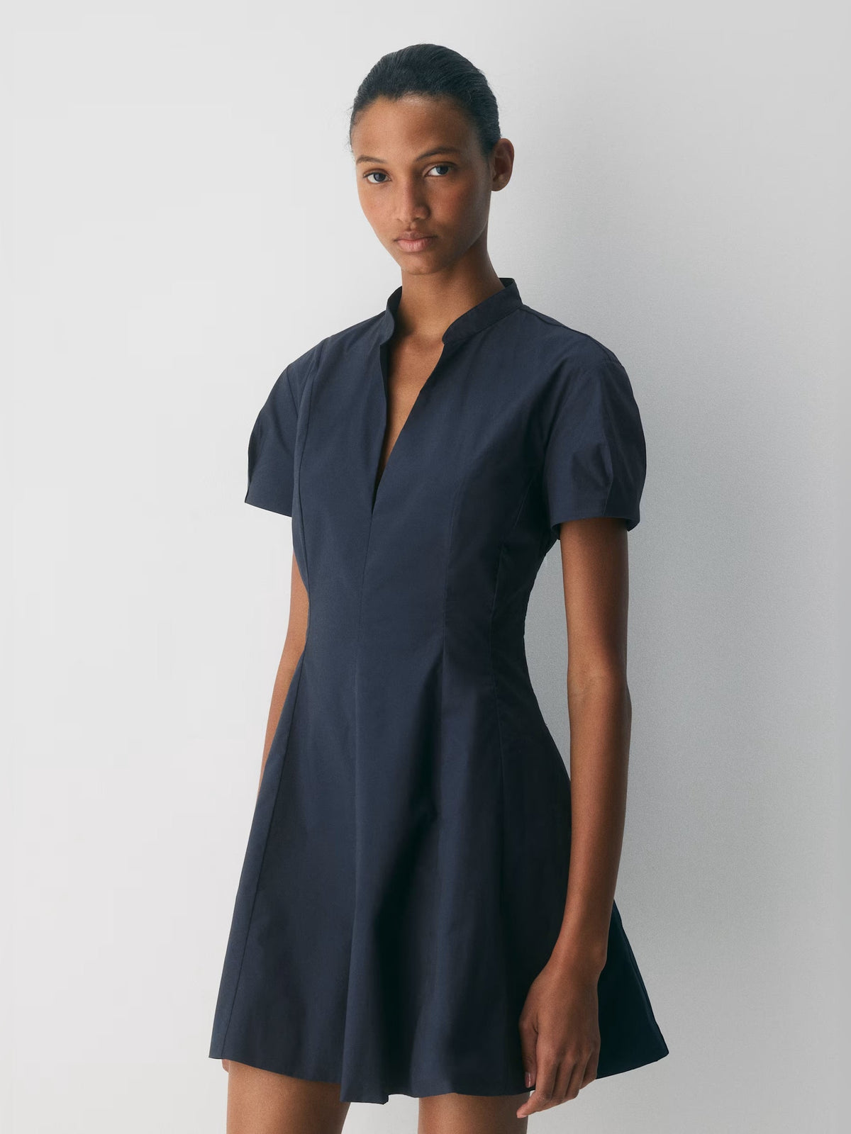Dark navy A-line mini dress with short sleeves and high neck, front close-up