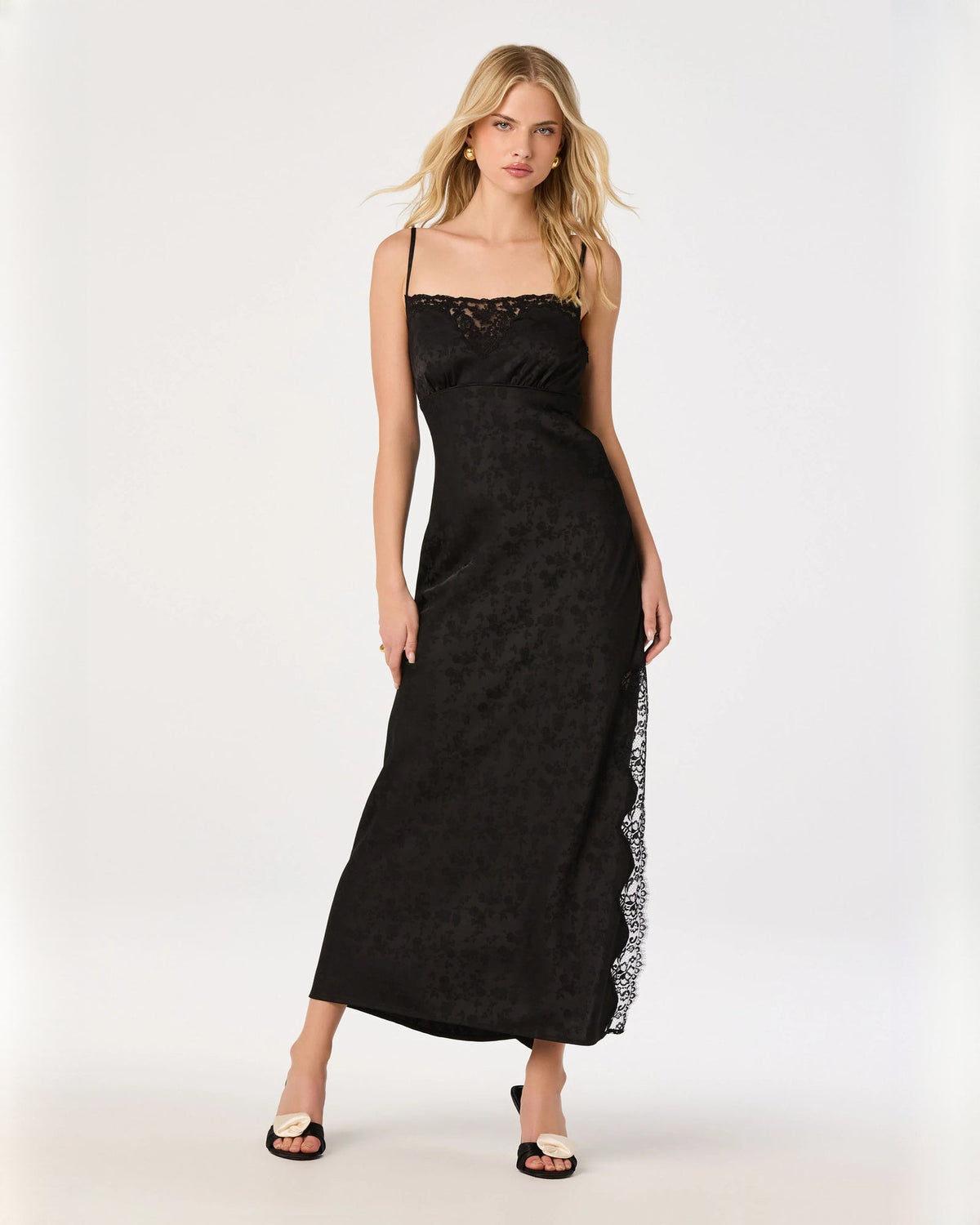 Black sleeveless A-line maxi dress with lace trim bodice and sheer side panel.
