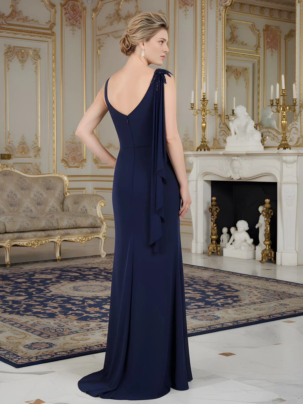 Navy back-view one-shoulder sheath gown with flowing drape and floor-length skirt
