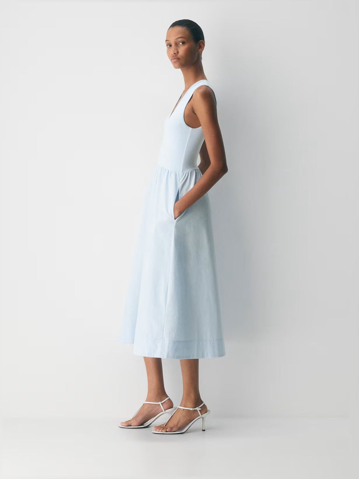 Teal sleeveless V-neck midi dress with gathered waist and flowing skirt