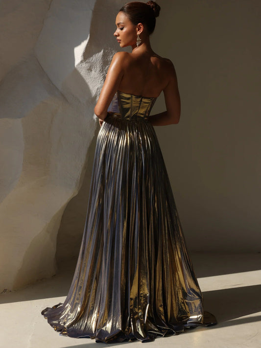 Back view: gold metallic strapless corset formal dress with pleated striped skirt