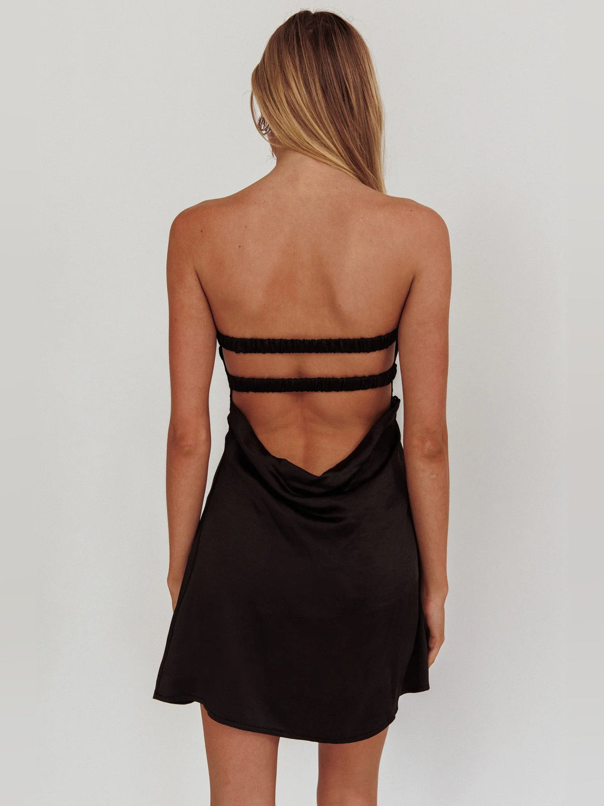 Black backless mini dress with thin straps and a V-shaped back cutout