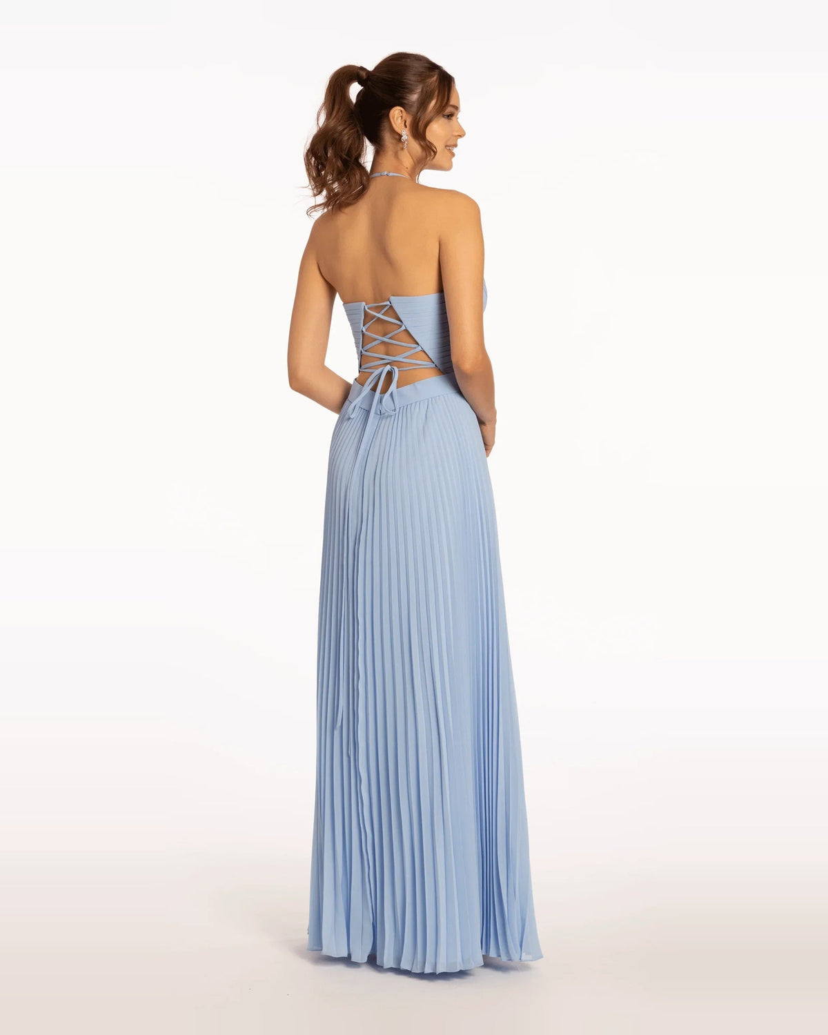 Back view of light blue pleated A-line floor-length prom dress with crisscross straps
