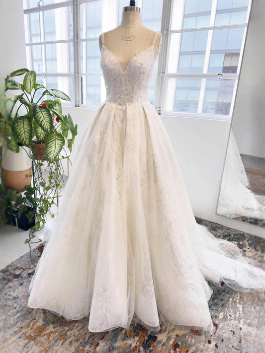 Ivory ball-gown wedding dress with lace open-back bodice and layered tulle skirt
