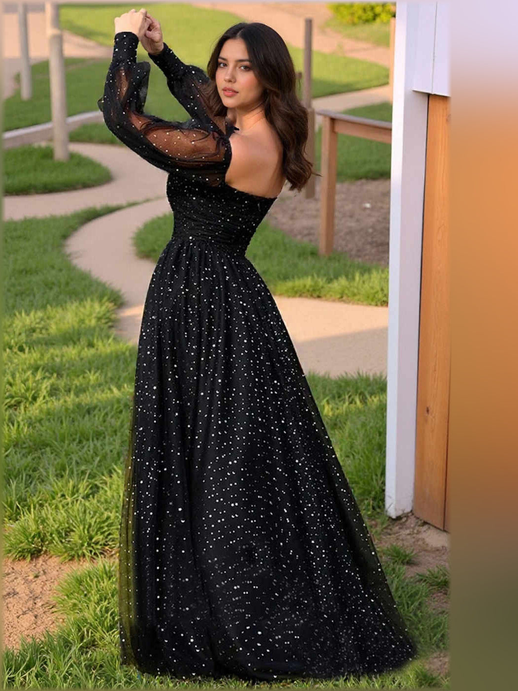 Black square-neck corset formal dress with long sheer sleeves and sparkling fabric