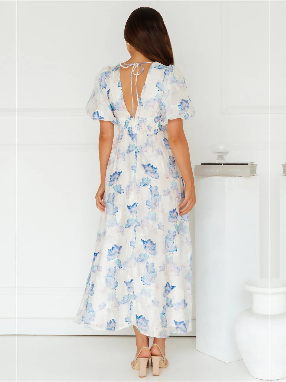 Blue a-line maxi formal dress with floral print, full-length back view