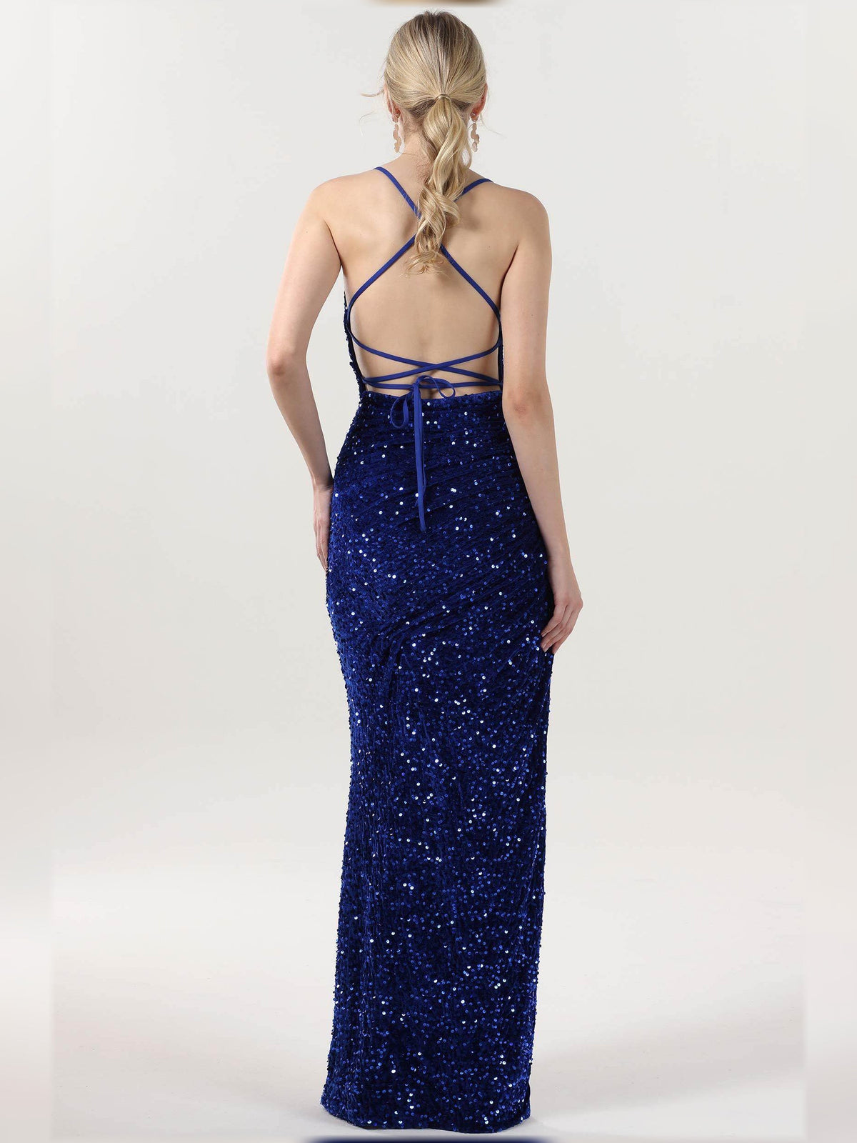 Back view of dark blue cowl neck sequin formal dress with crisscross straps and slit