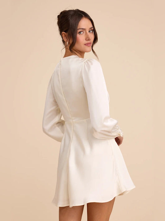 Ivory satin mini dress with long sleeves and tied waist, viewed from the back