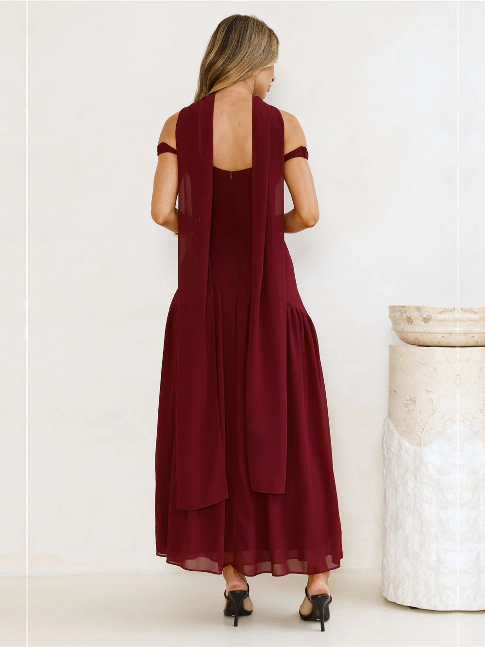 Burgundy a-line maxi formal dress with pleated skirt, full-length back view