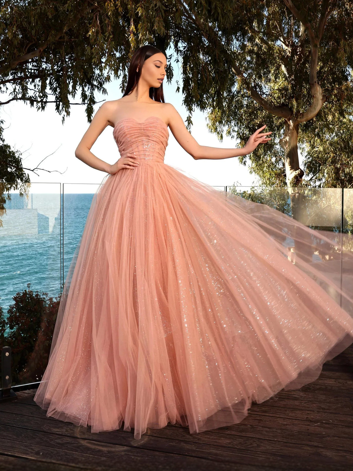 Dusty pink strapless A-line prom dress with ruched sweetheart bodice and sparkly tulle
