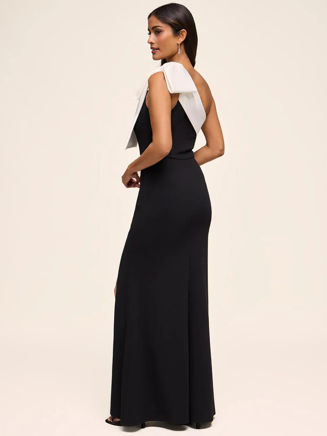 Black one-shoulder crepe mermaid formal dress with white bow detail and slit