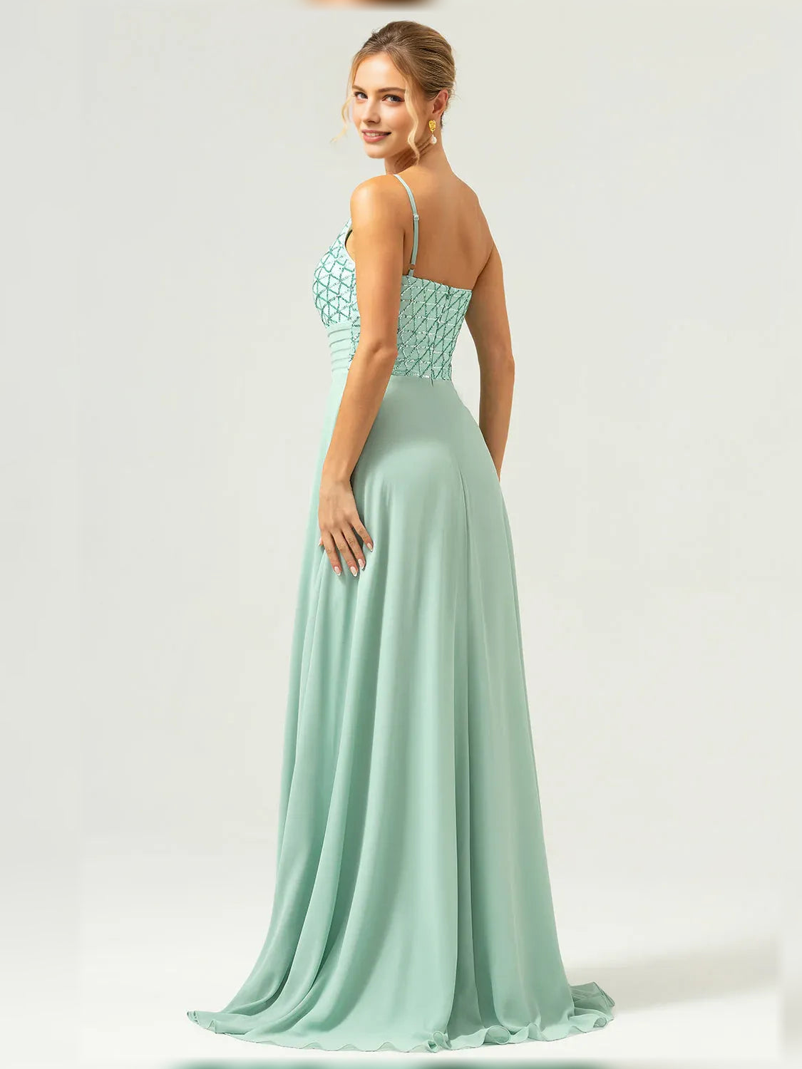 Mint green one-shoulder formal dress with pleated skirt and beaded geometric bodice