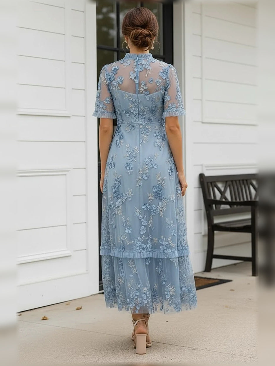 Back view of steel blue floral tulle dress, high neck and layered ruffle skirt, A-line