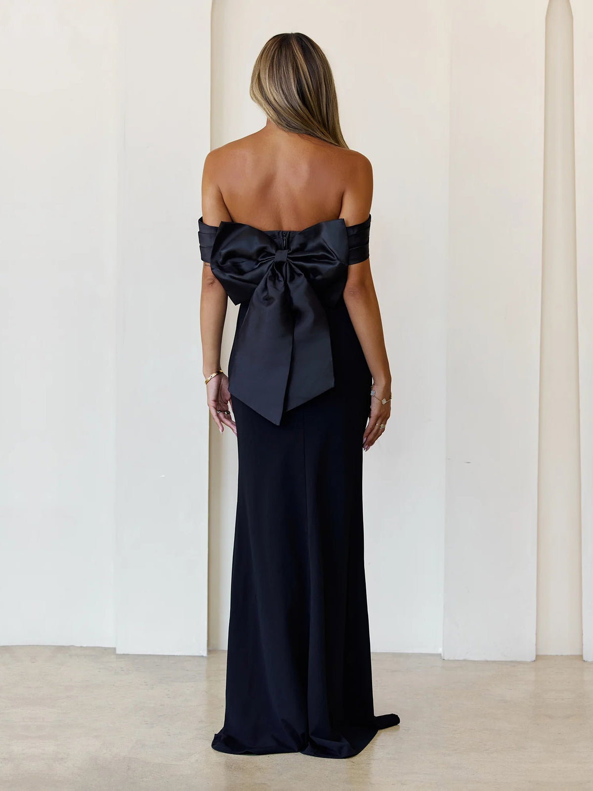 Black sheath maxi formal dress with bow detail, full-length back view