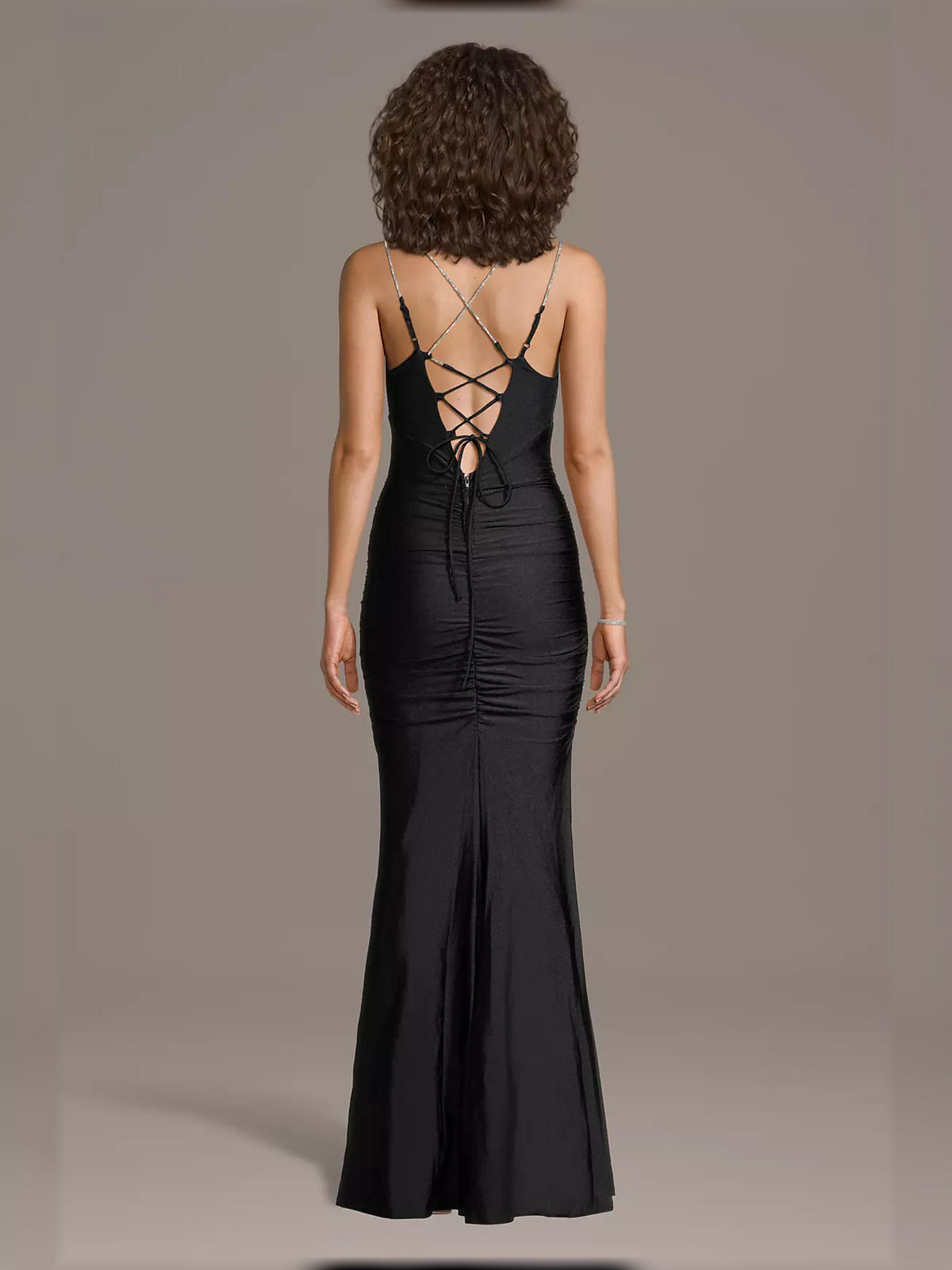 Backless black mermaid dress with crisscross lace-up straps and ruched corset seams.