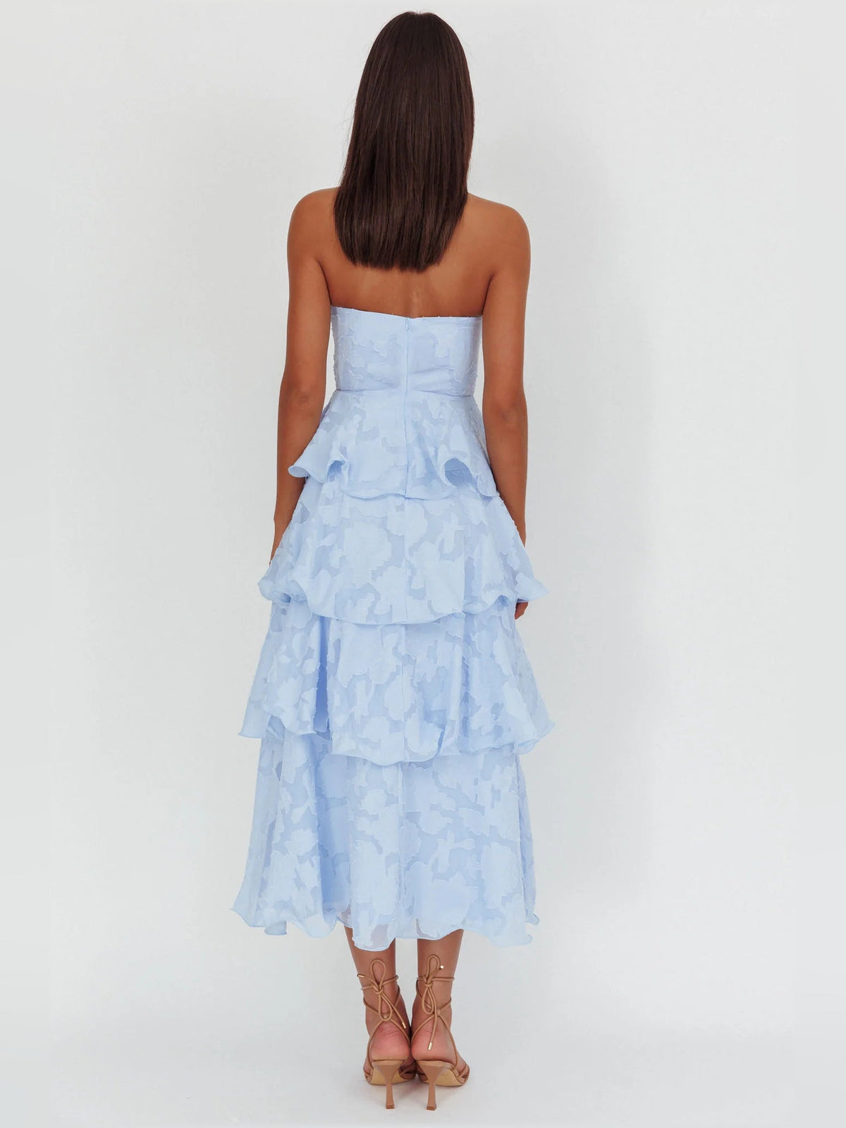 Back view of blue strapless layered midi formal dress with tiered ruffles
