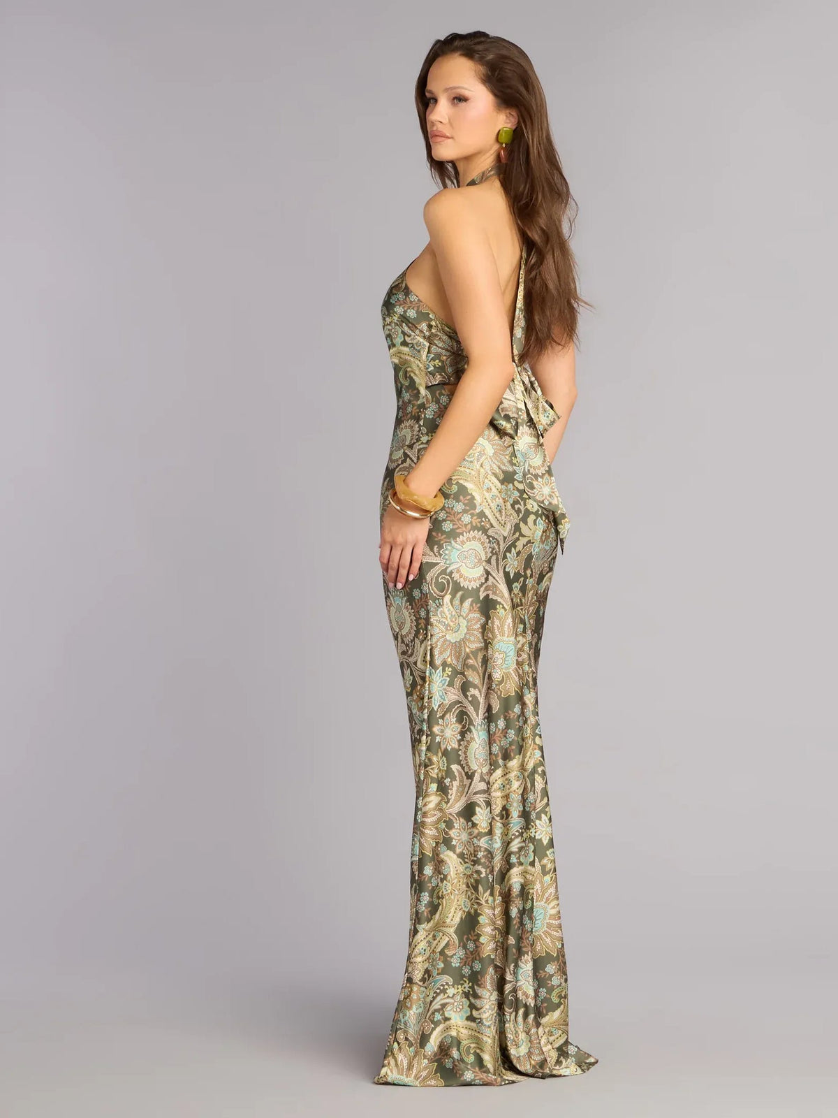Printed halter-neck open-back maxi dress, side view of olive and teal paisley print