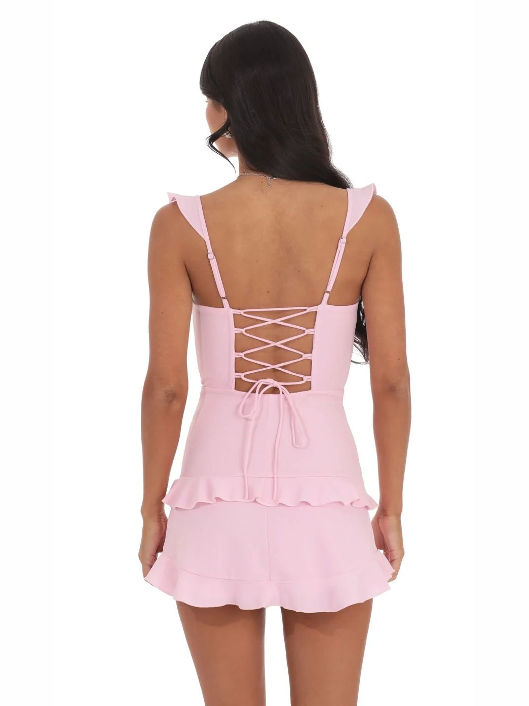 Blush pink mini dress back view with crisscross lace-up straps and ruffled hem