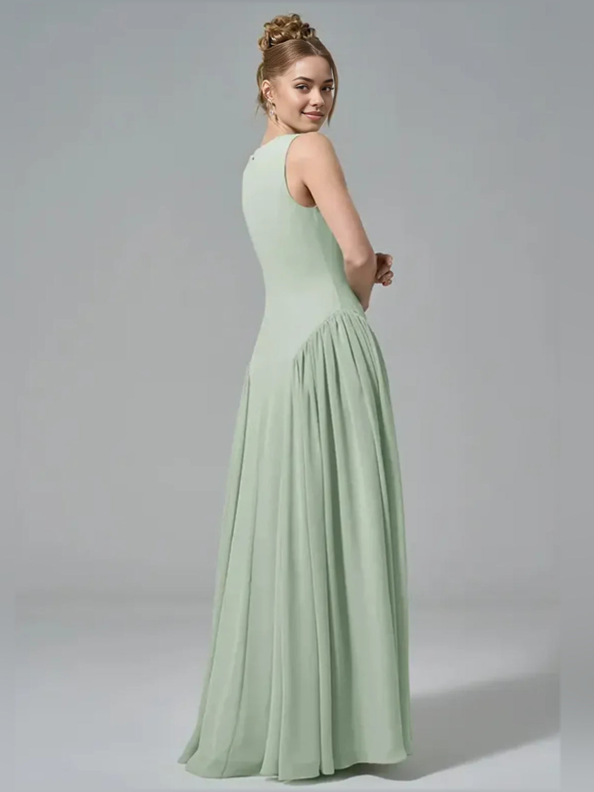 Mint green chiffon A-line dress with boat neck, gathered waist, sleeveless side view.