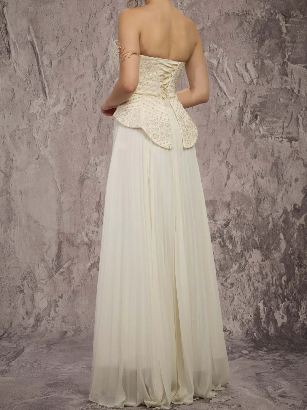 Cream strapless peplum corset A-line formal dress with lace back and pleated chiffon skirt