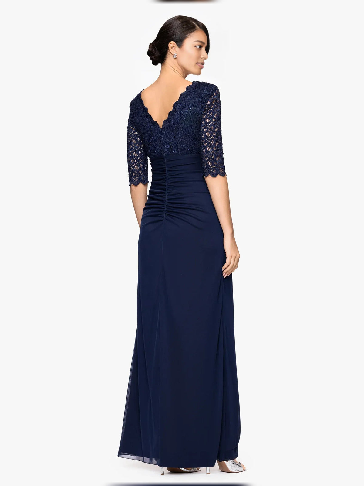 Dark navy V-neck jersey A-line gown with ruched waist and lace elbow sleeves, side view