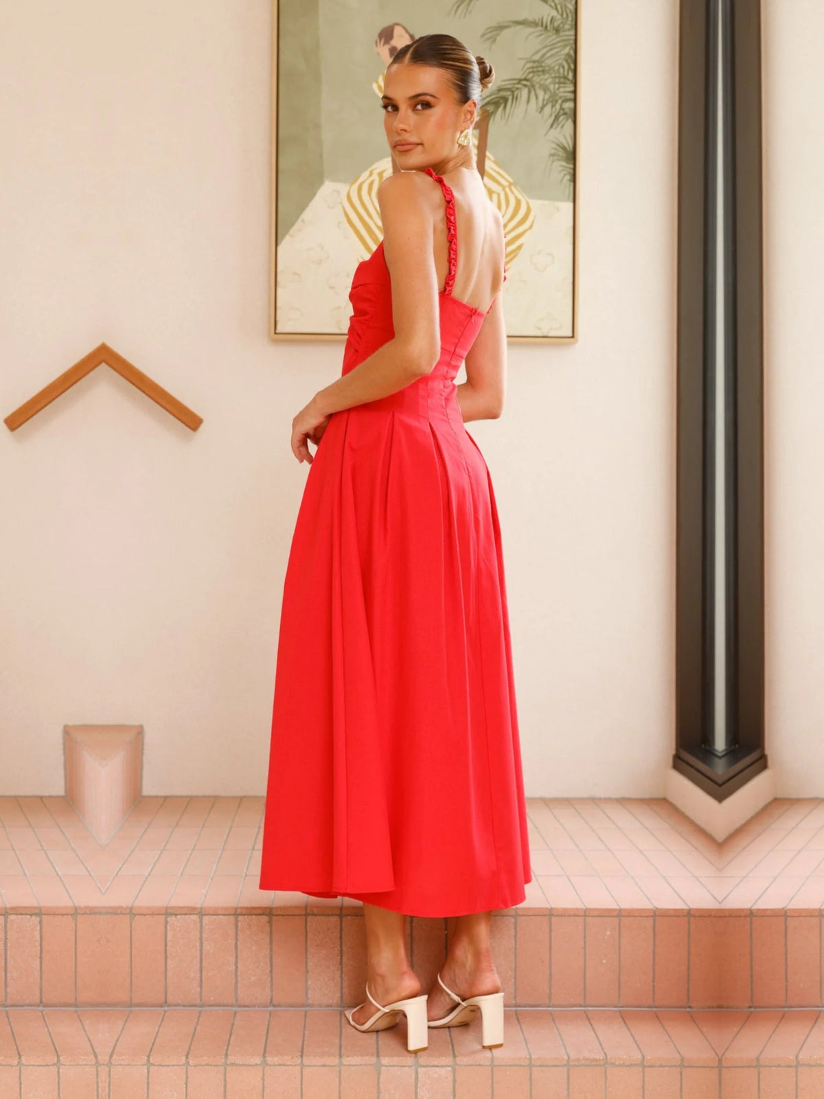 Red a-line maxi formal dress with pleated skirt, full-length back view