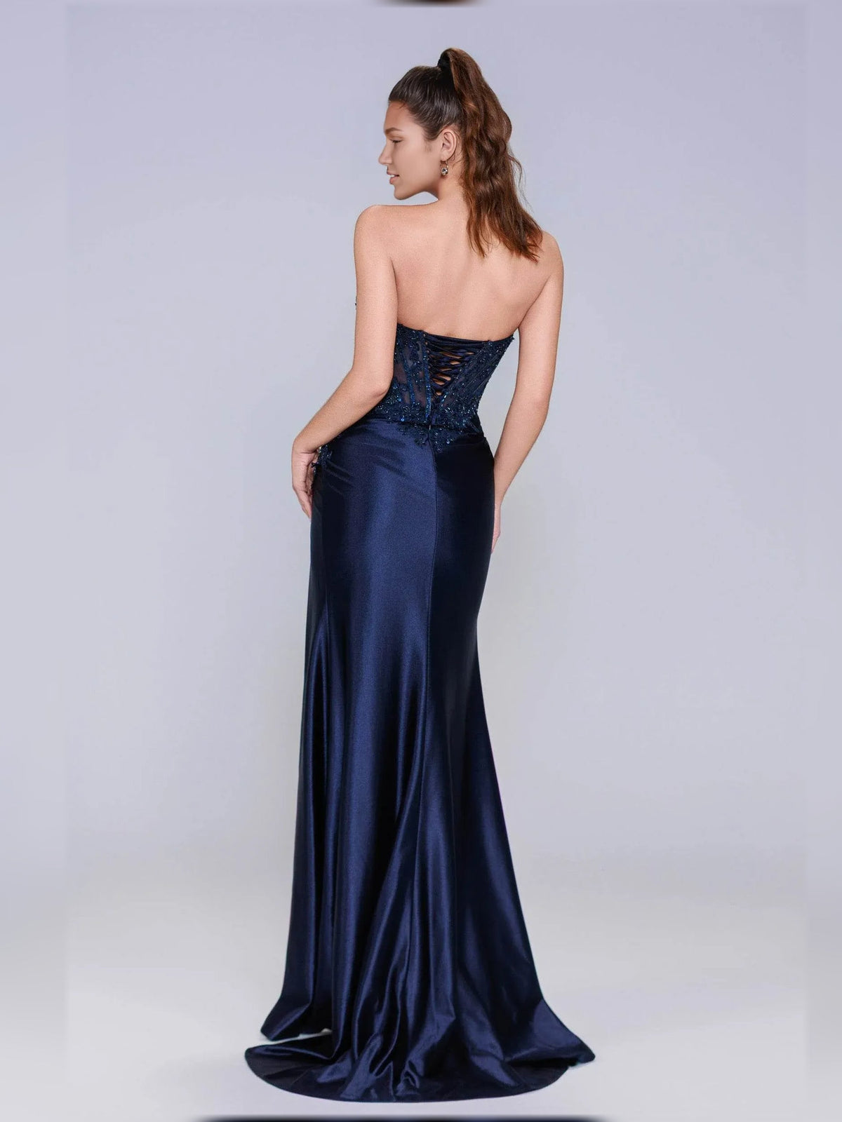 Navy blue sleeveless formal corset dress with lace sparkle back and long drape