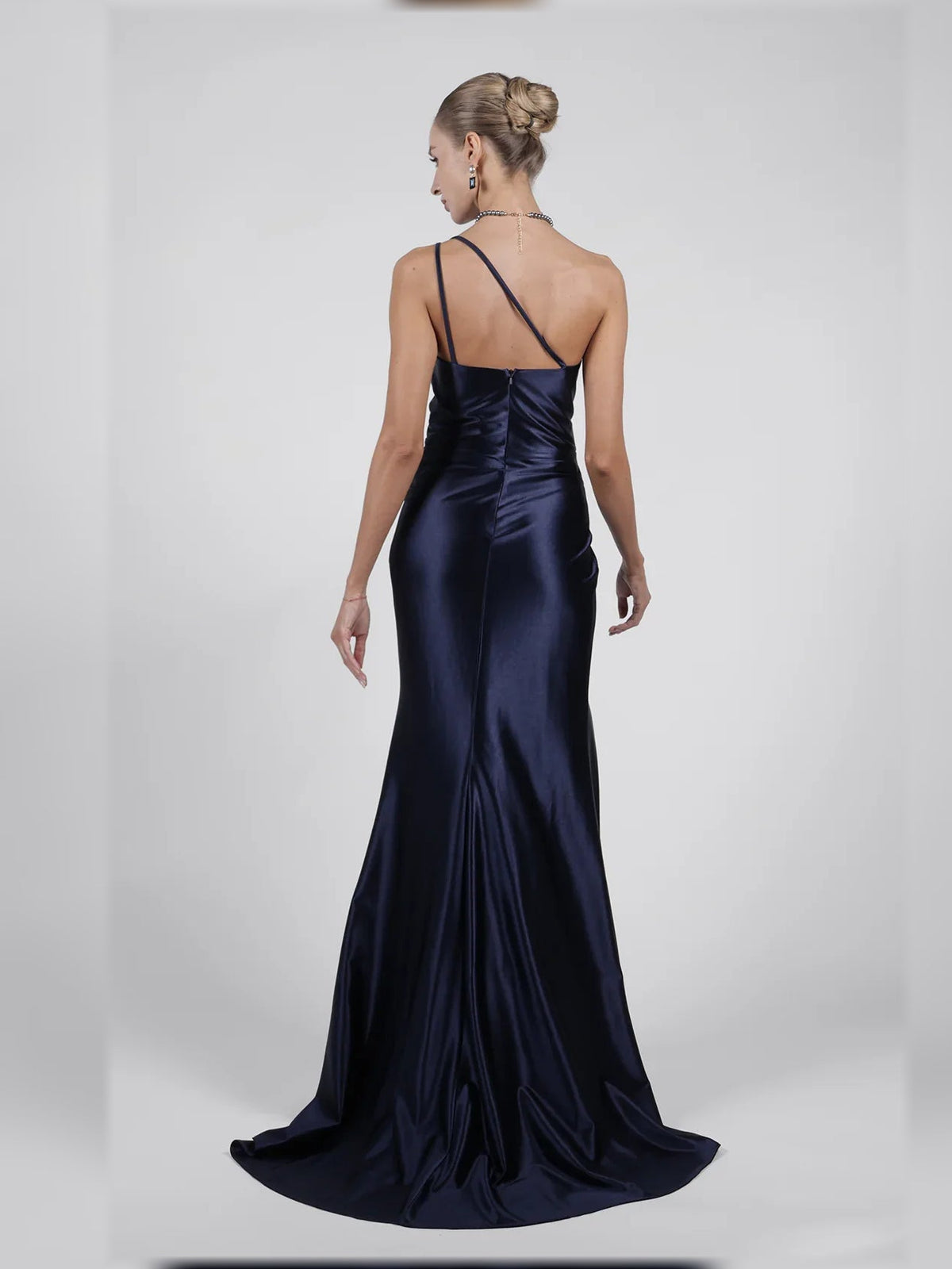 Navy one-shoulder formal dress with open back, ruched detailing, and long slit