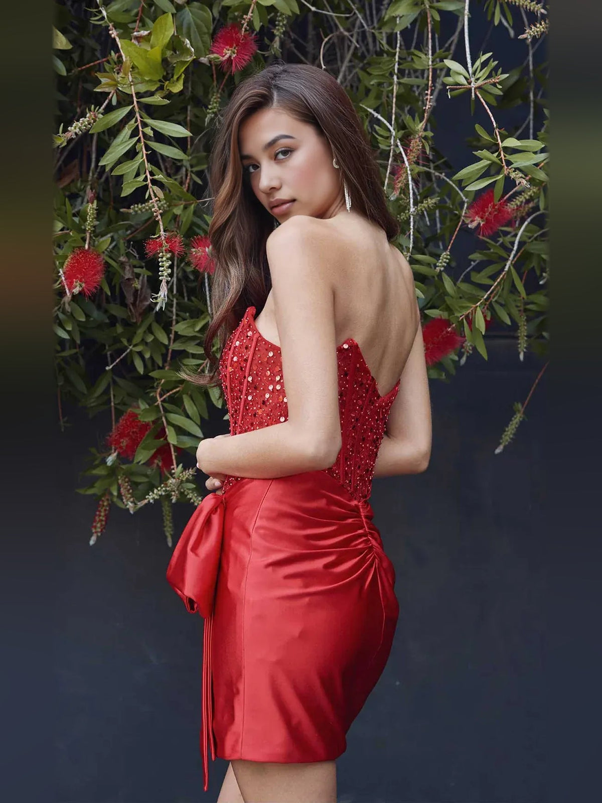 Crimson red satin mini dress with strapless ruched bodice and open back drape bow