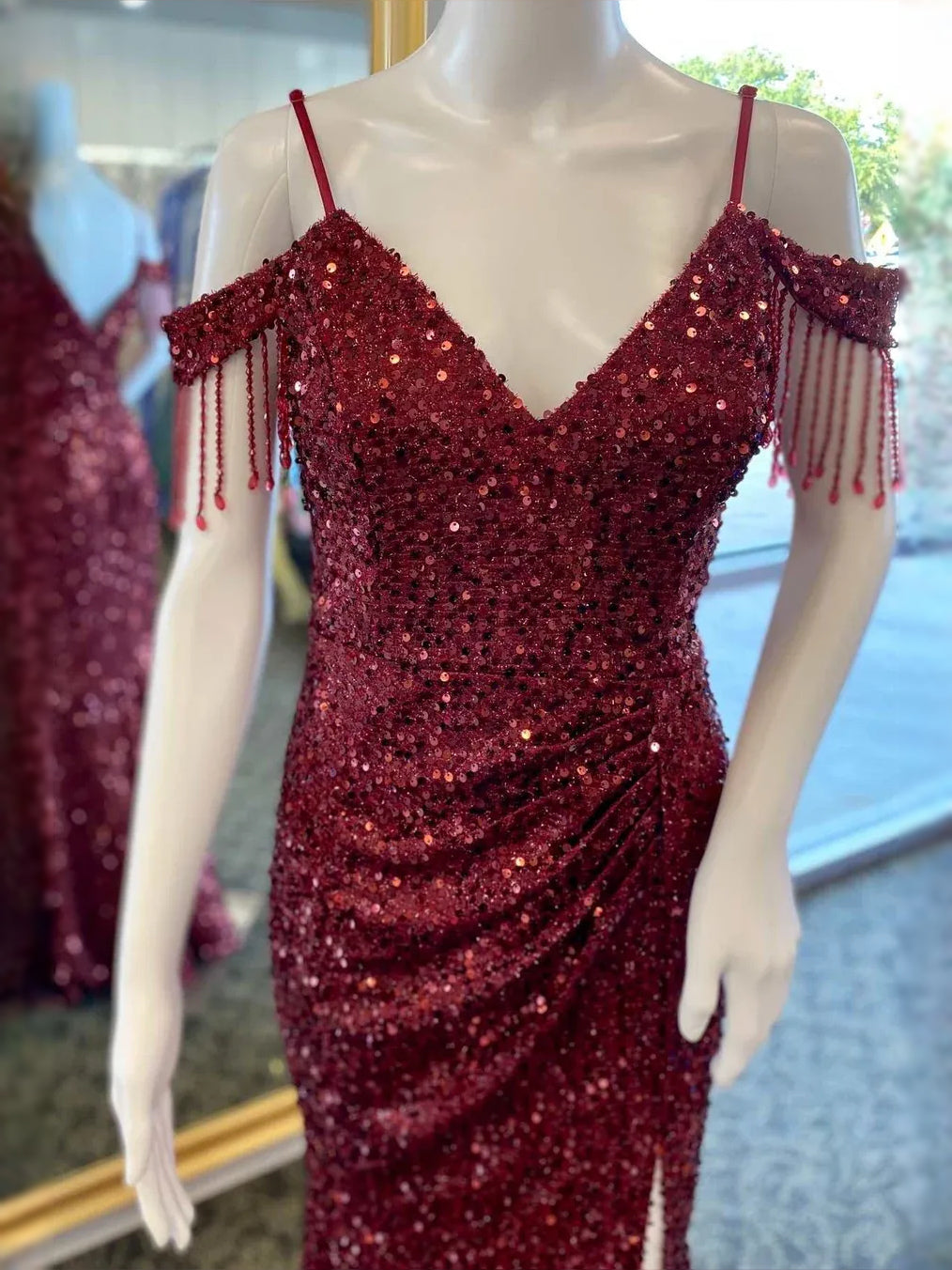 Deep red sequin V-neck fitted dress with beaded fringe sleeves and body-hugging skirt