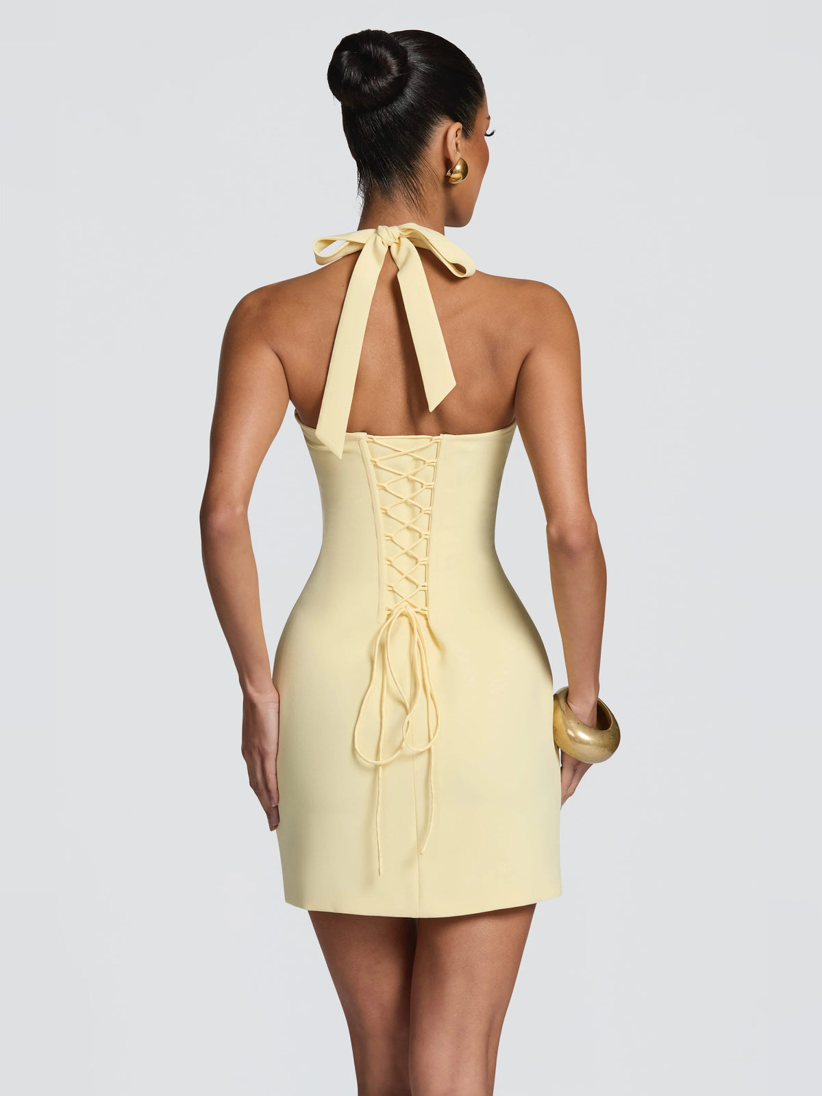 Lemon mini dress, lace-up back with draped tie and halter straps.