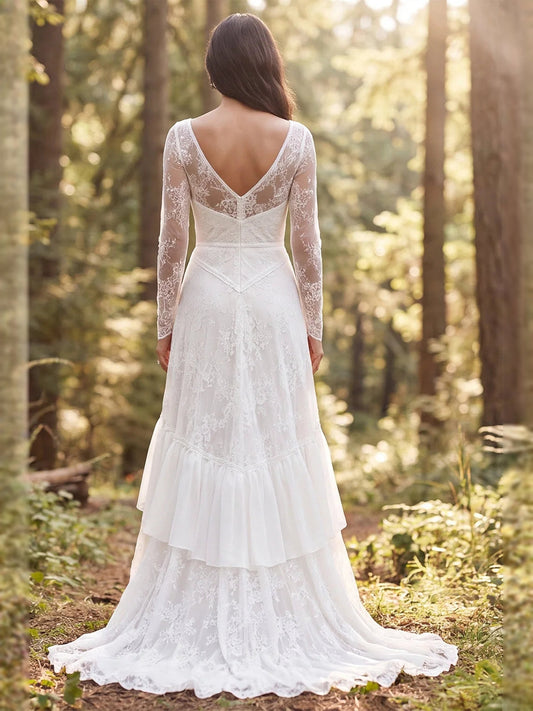 Ivory A-line wedding dress with lace long sleeves, open-back V and tiered ruffle skirt