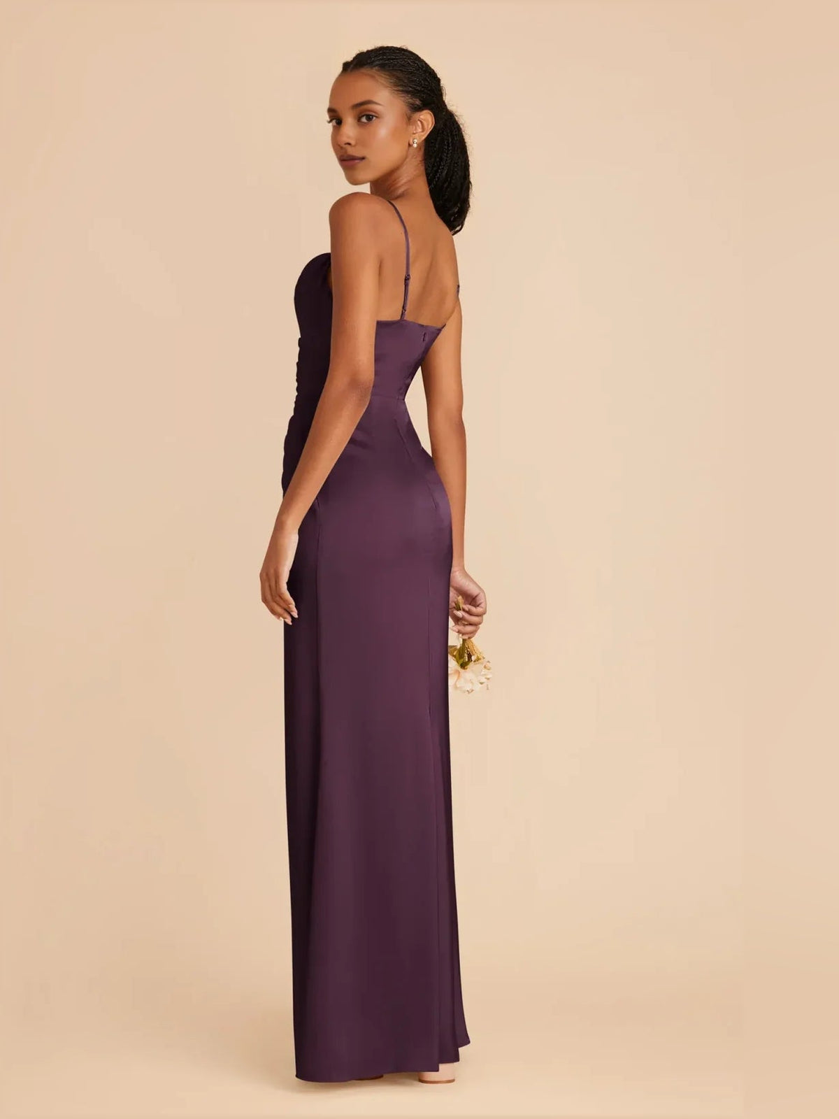 Plum satin maxi dress with ruched cowl neckline, thin straps, and front slit side view